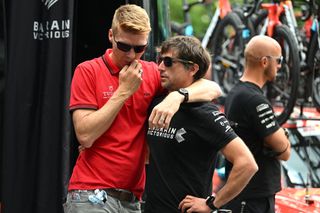 Marcel Sieberg of Tudor Cycling consoles Bahrain Victorious staff at the start of stage 6 of the Tour de Suisse.