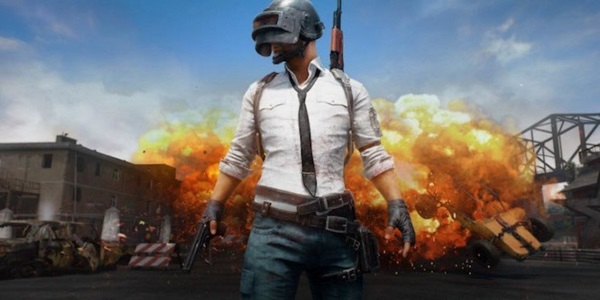 A guy stands in front of an explosion in PUBG.