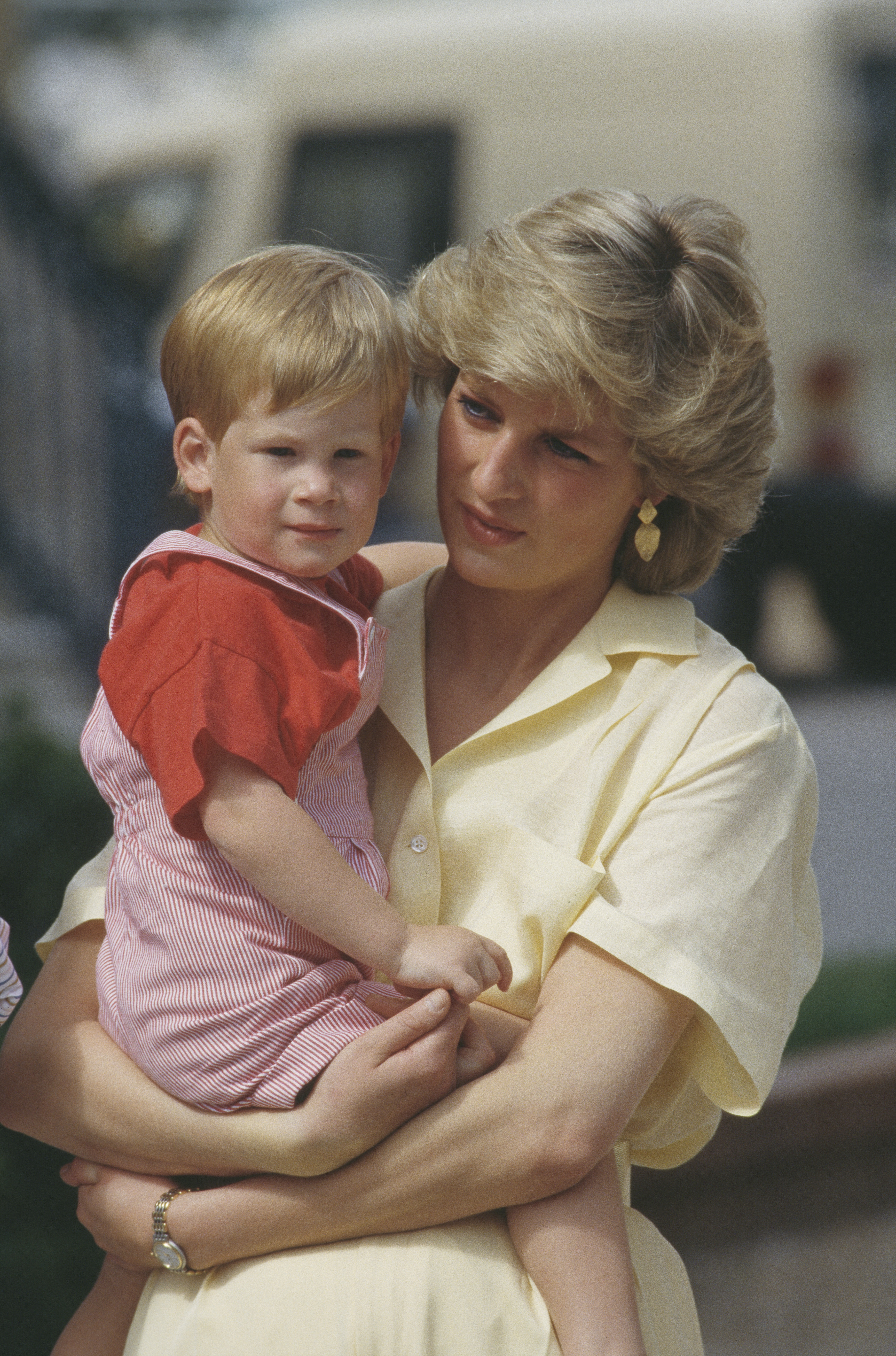 Princess Diana holding Prince Harry when he was young.
