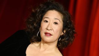 Sandra Oh is pictured with bouncy curls and wearing a dark, wine-red lipstick look at the Fourth Annual Academy Museum Gala held at Academy Museum of Motion Pictures on October 19, 2024 in Los Angeles, California.