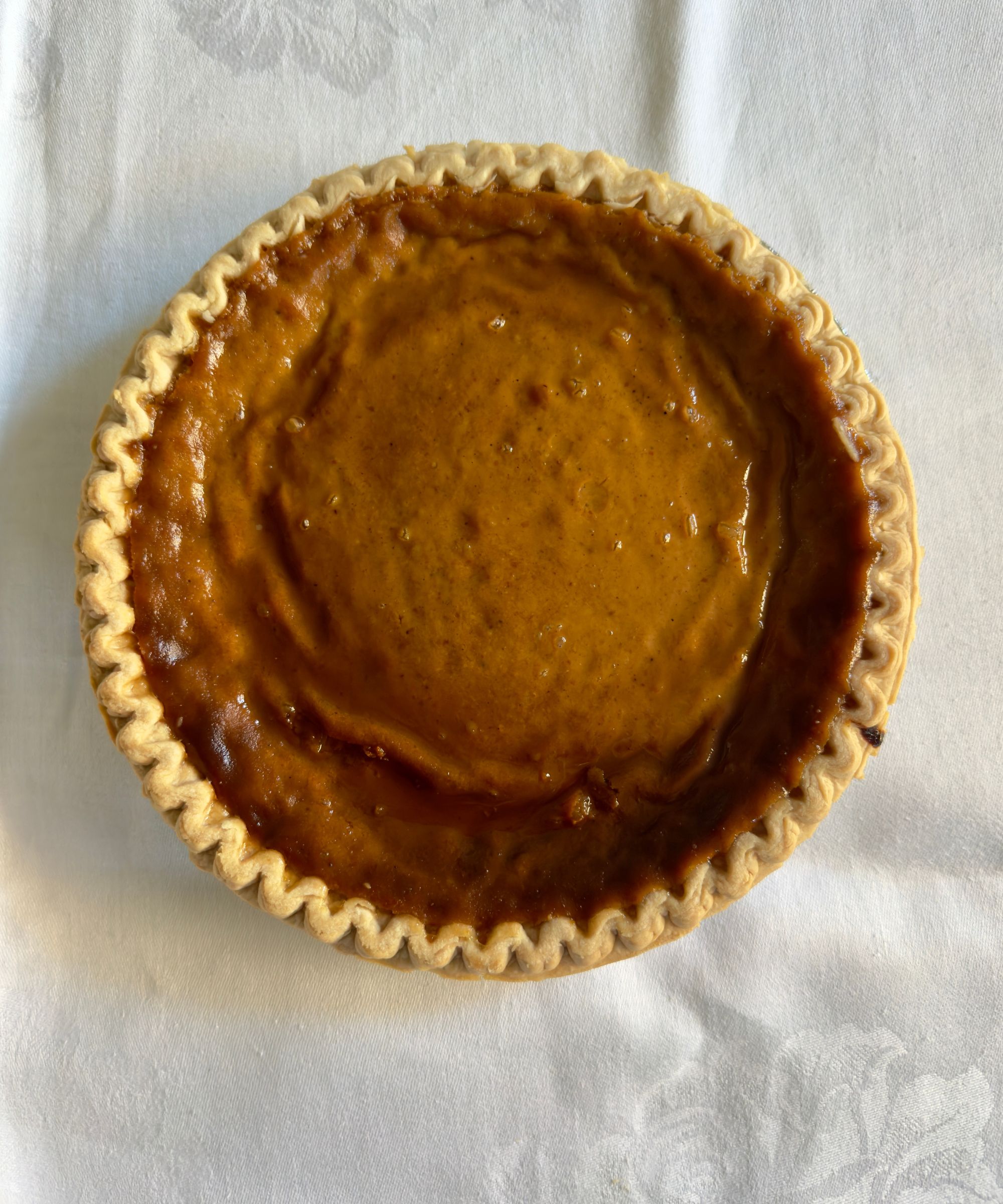 Pumpkin pie on a white tablecloth