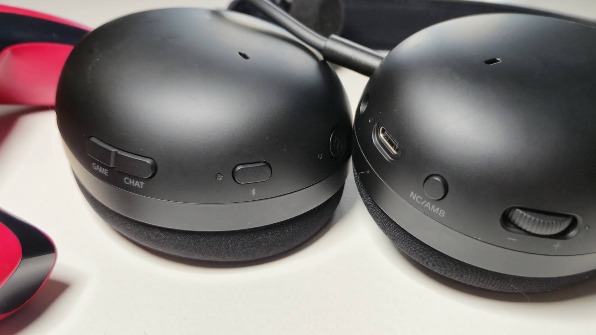 Photo of the onboard controls at the side of the H9 II headset, while it&#039;s sitting on a white table.
