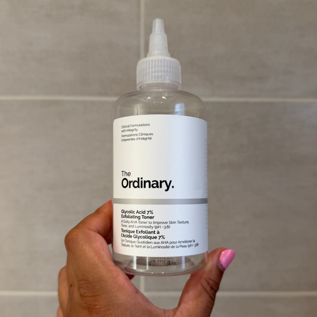 Hand holding empty bottle of The Ordinary Glycolic Acid 7% Exfoliating Toner