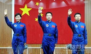 The crew of China's Shenzhou-9 mission, set to launch in June 2012, waves. L to R, Liu Yang (China's first female astronaut), Jing Haipeng, Liu Wang.