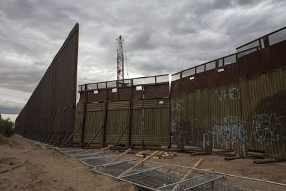 A section of the new border fence between Mexico and the US under construction