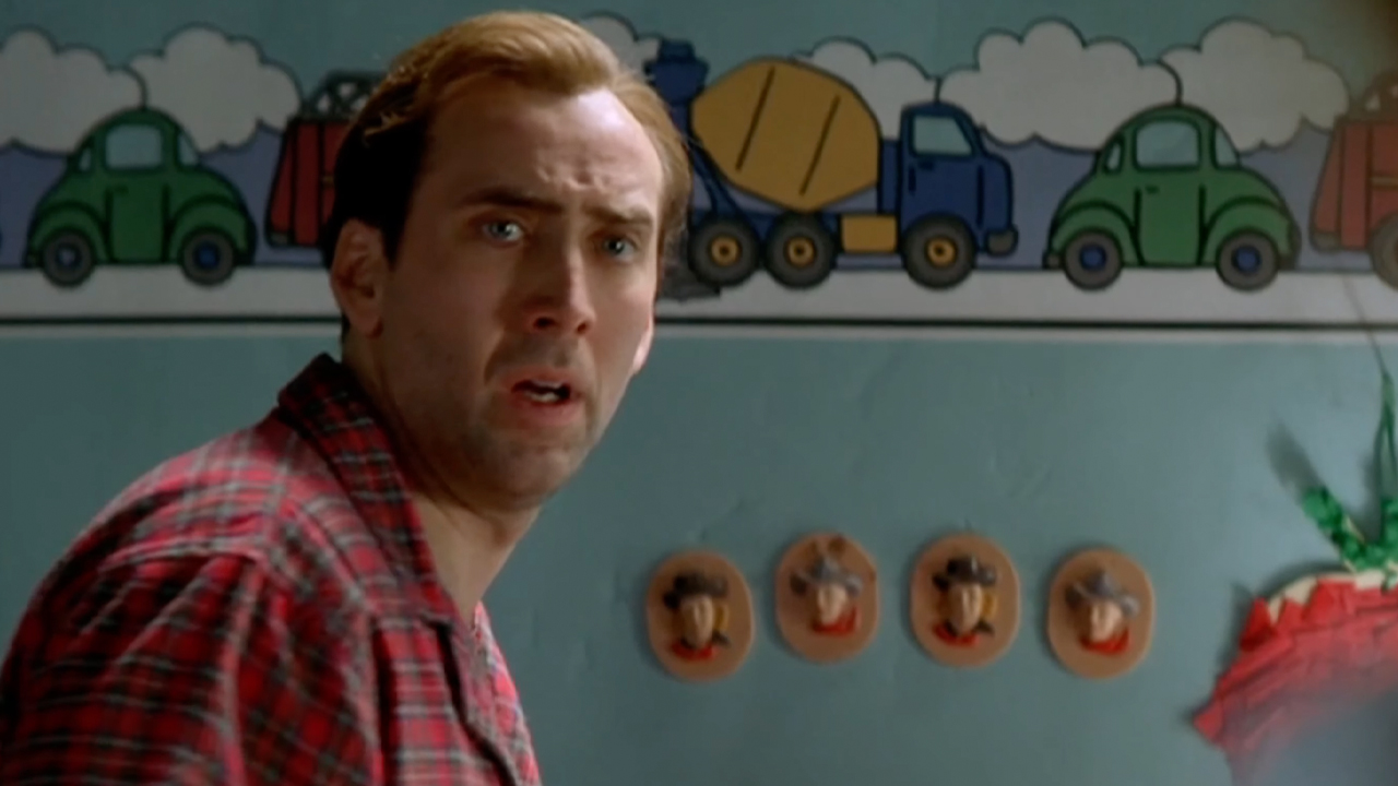 Nic Cage, in a kids room wearing red plaid pajamas, The Family Man.