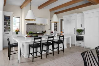 Modern white farmhouse kitchen with large kitchen island and pendant lights
