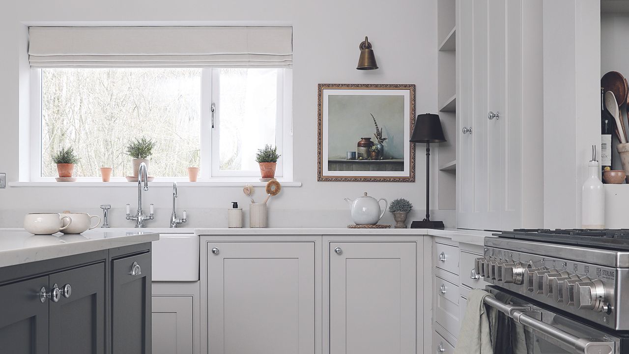 White shaker kitchen with black island and large window