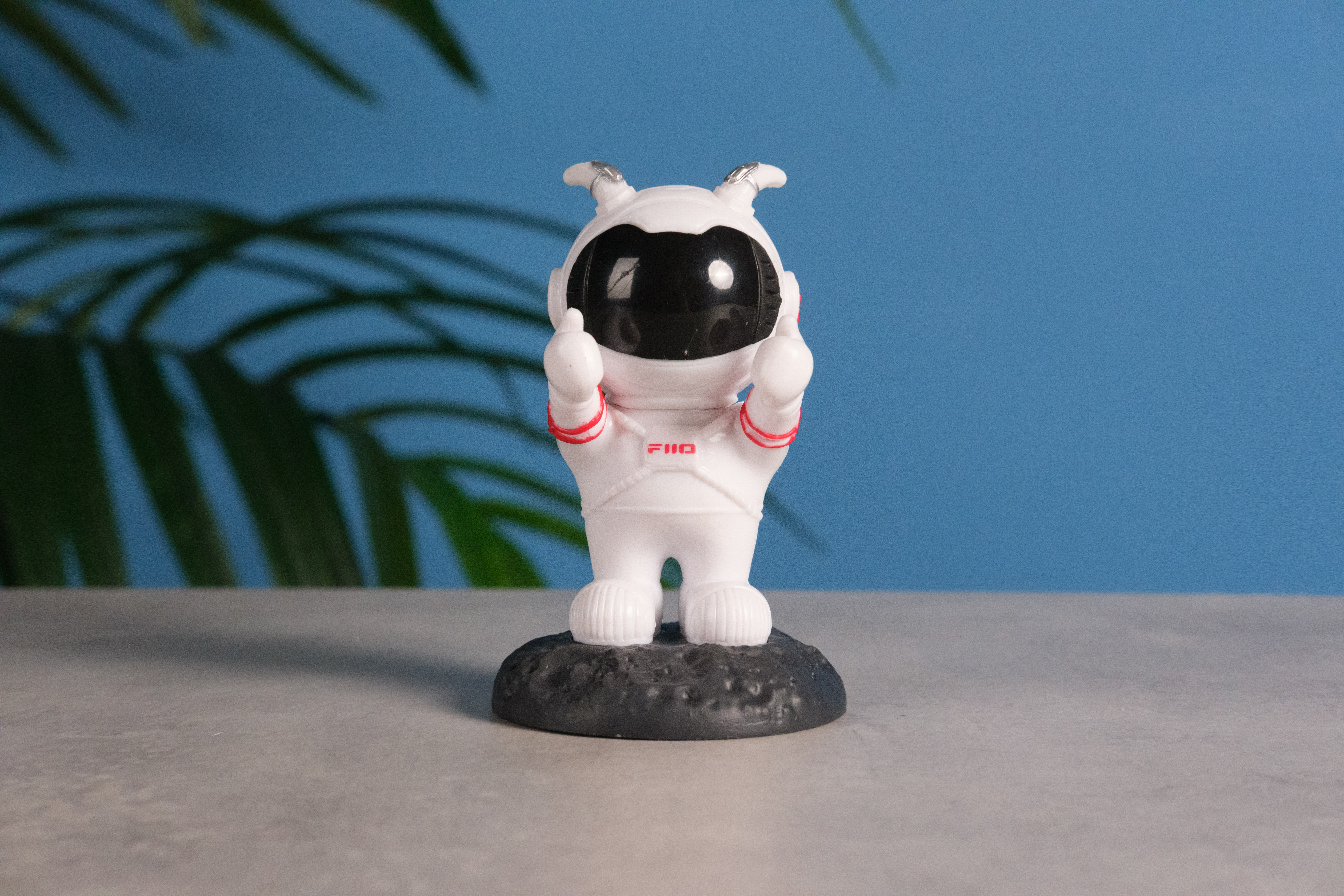A photo of an astronaut toy against a blue background, taken on the Fujifilm X-E5