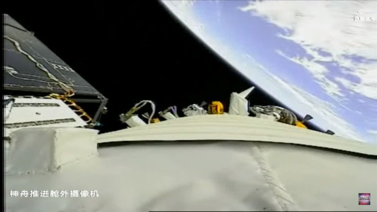 The blue Earth behind a Chinese Shenzhou 16 spacecraft with solar arrays deployed