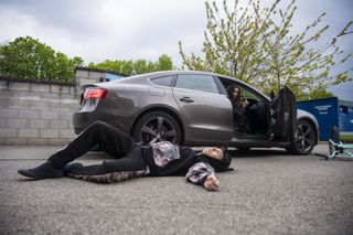 Carla Barlow knocks a boy off his bike as he lies on the ground next to her car.