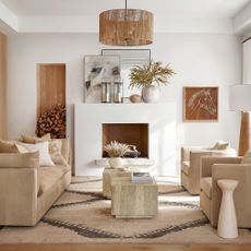 living room with beige sofa and armchairs white walls wooden panelling and neutral decor