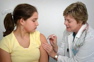 girl getting flu shot from doctor