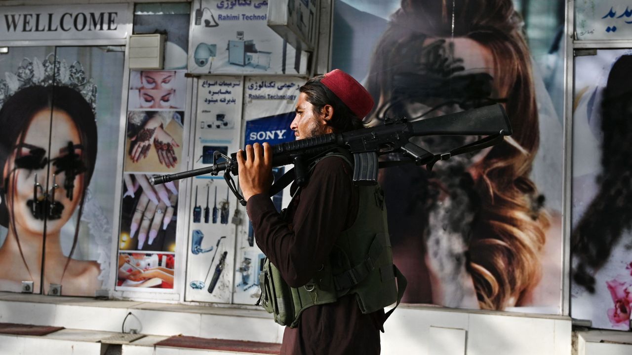 A Taliban fighter walks through central Kabul