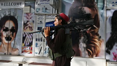 A Taliban fighter walks through central Kabul