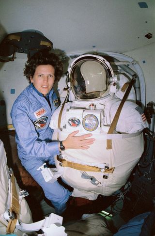 Astronaut Kathy Sullivan poses for a picture with her space suit during a 1995 shuttle mission. Sullivan was the first American woman to go on a spacewalk.