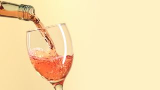 Pouring rose wine - stock photo