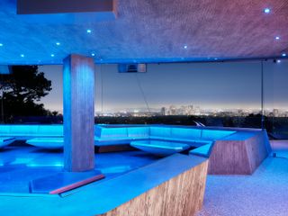 nighttime shot of glazed entertainment space at the Goldstein Entertainment Complex at the sheats-goldstein residence