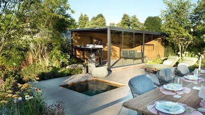 paved backyard area with water feature and garden room