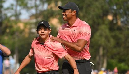 Tiger and Charlie walk on the fairway