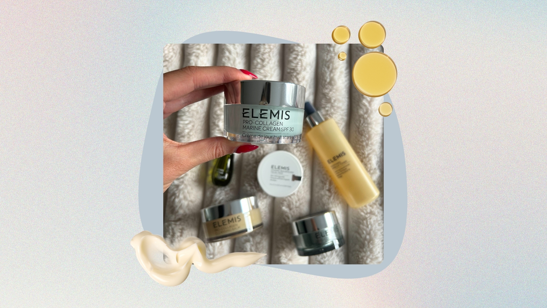 Image of hand holding Elemis Marine Cream with other Elemis products in the background, on a pastel watercolour background with cream and oil product swatches