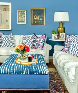 Blue living room with pale gray sofas