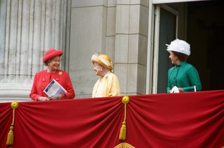 Queen Elizabeth, The Queen Mother, Princess Margaret standing on the balcony of Buckingham Palace in bright coats and hats for VE Day 1995.