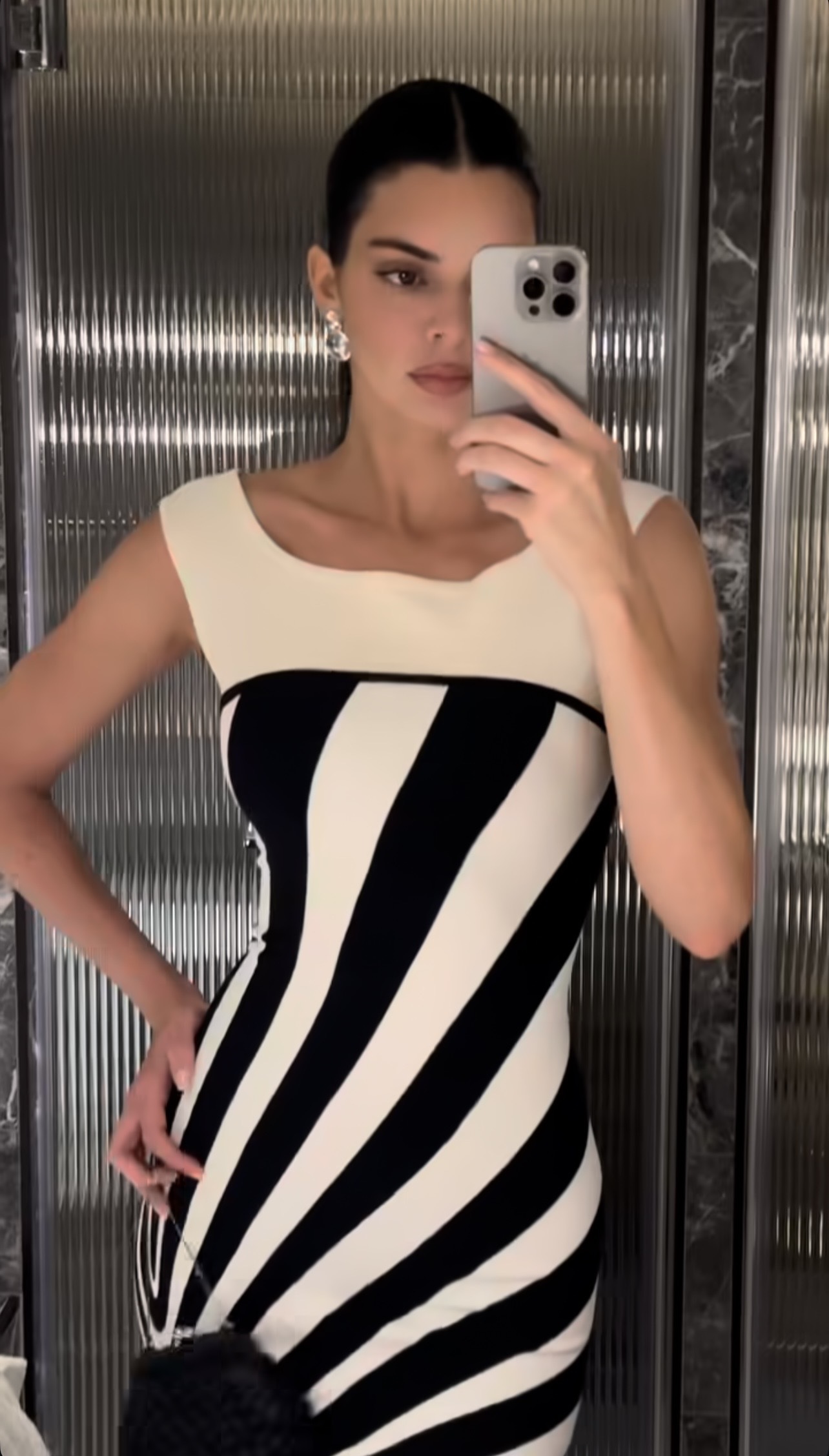 Kendall Jenner wore a black-and-white Herve Leger dress with an itty-bitty coin purse.