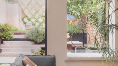 The view through a window of an urban garden with a stylish patio heater 