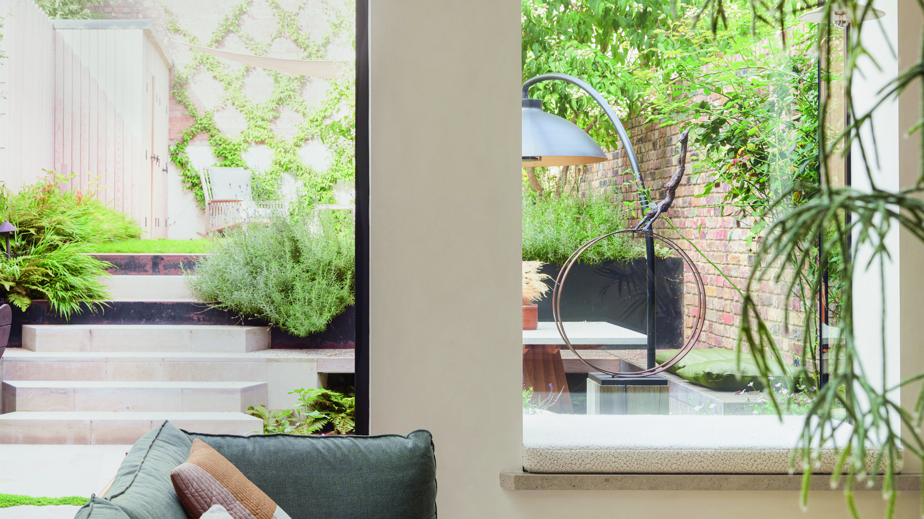 The view through a window of an urban garden with a stylish patio heater 