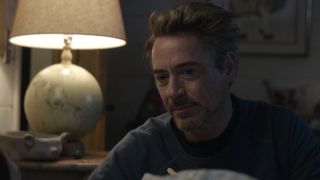 Tony Stark seated next to his daughter Morgan's bed