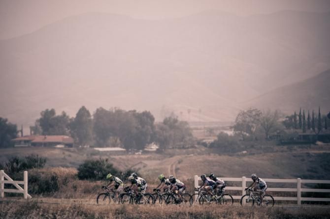 Riders head along the foggy hills.