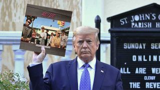 Donald Trump holding a copy of AC/DC's Dirty Deeds Done Dirt Cheap