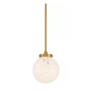 A pendant light with a gold base and a beige dome at the bottom of it