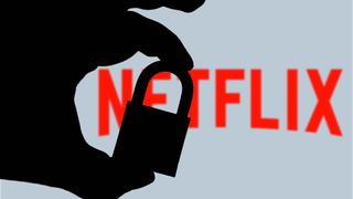 Silhouette of a hand holding a padlock in front of the Netflix logo