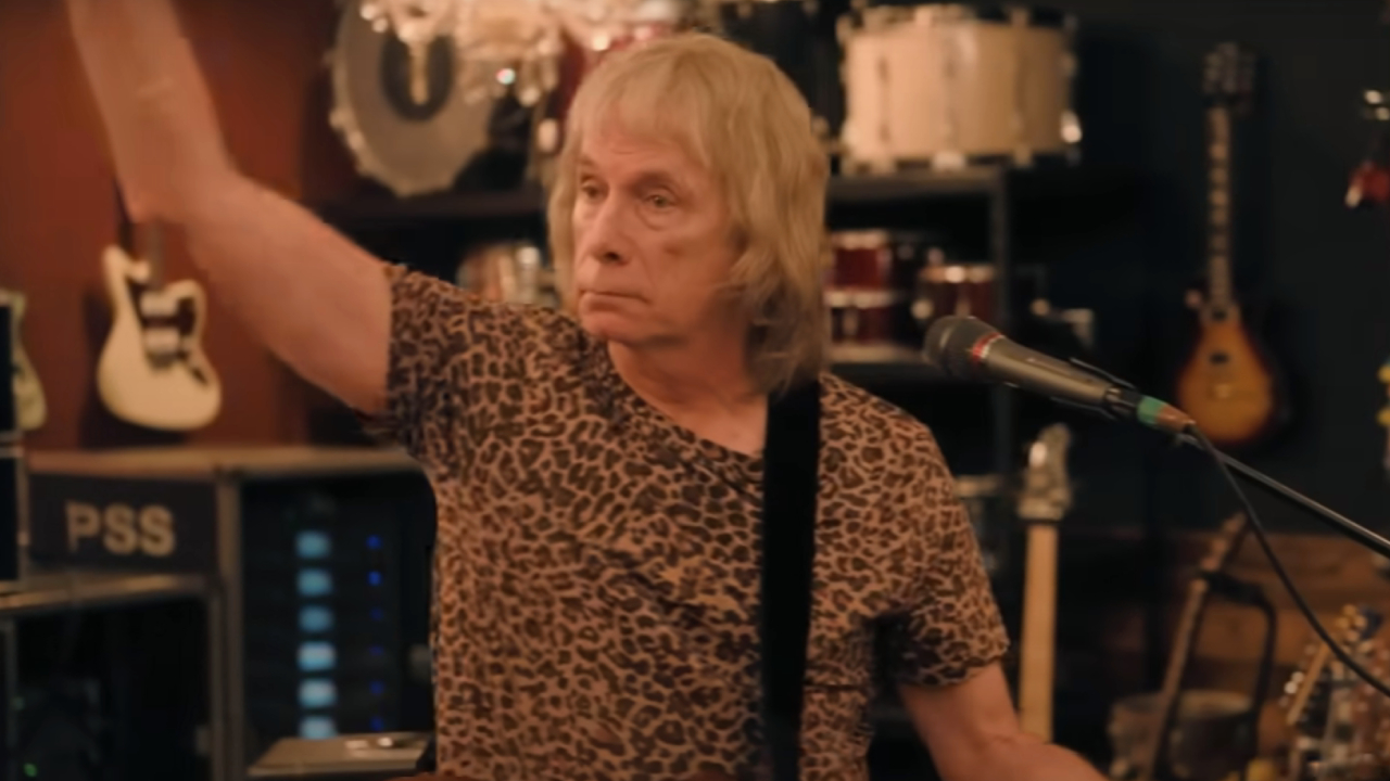 Christopher Guest playing guitar in Spinal Tap II: The End Continues