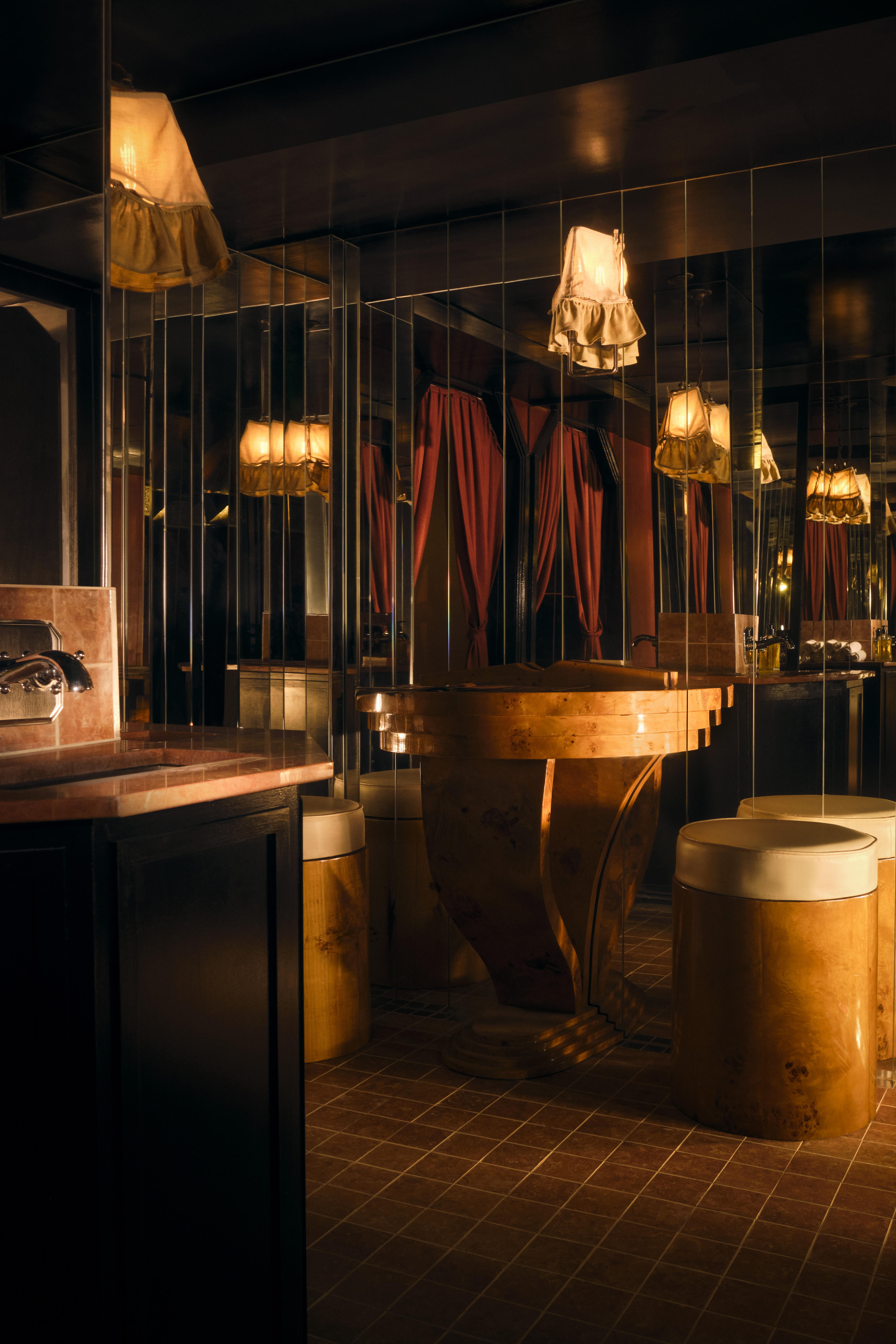 A golden-hued, dimly lit nightclub features velvety red or ochre plush fabrics, reflective surfaces, Art Deco-inspired sconces, and an air of mystery.