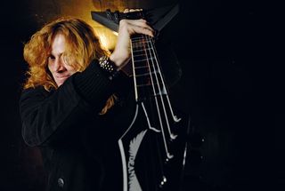 Dave Mustaine poses with a Dean guitar