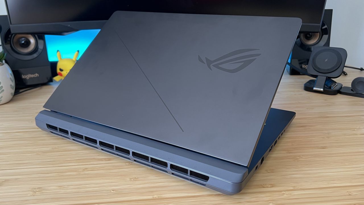 Asus ROG Strix G16 gaming laptop lid and rear vents on a wooden desk