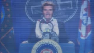 Fred Willard stands panicked behind his presidential podium in Wall-E.