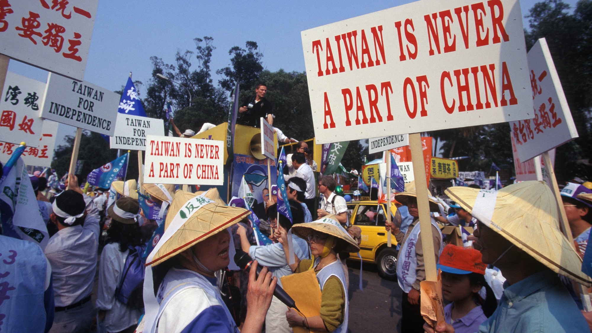 Protesters in Taiwan hold signs opposing China