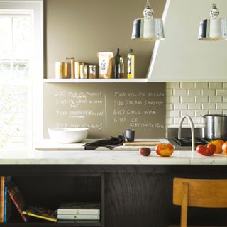 wall planner in Gettysburg Gray from Benjamin Moore in a kitchen with black cabinetry, open shelving, painted cooker hood