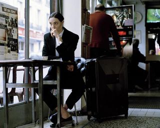 Dror For Tumi Paris - woman sitting alone in cafe