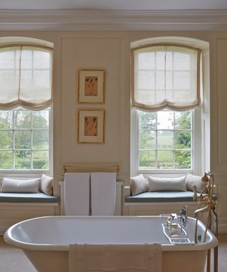 Todhunter Earle bathroom design with double blinds above a freestanding bath