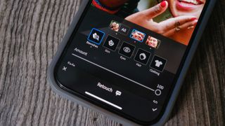 A photo of an iPhone with the Lightroom Mobile blemish slider on the screen