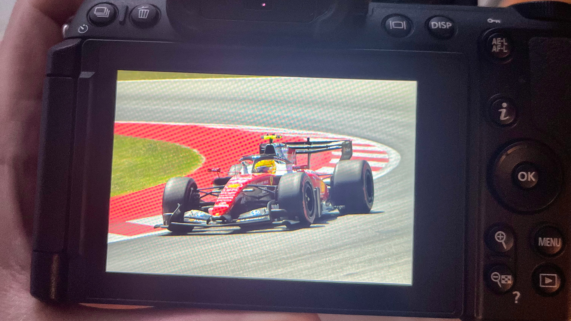Back of Nikon camera showing photo of Lewis Hamilton's F1 Ferrari on Playback screen 