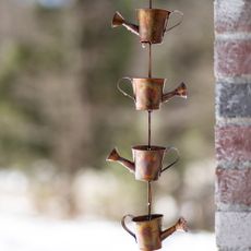Copper rain chain shaped as watering cans