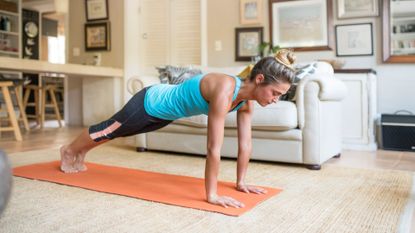 A woman completing an ab workout at home 