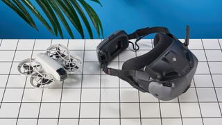 DJI Goggles N3 FPV headset in a dary gray colorway next to a DJI Neo