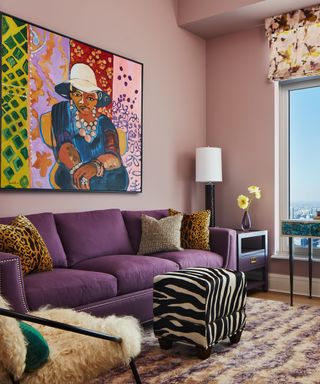 Purple sofa, zebra print footstool, pink walls